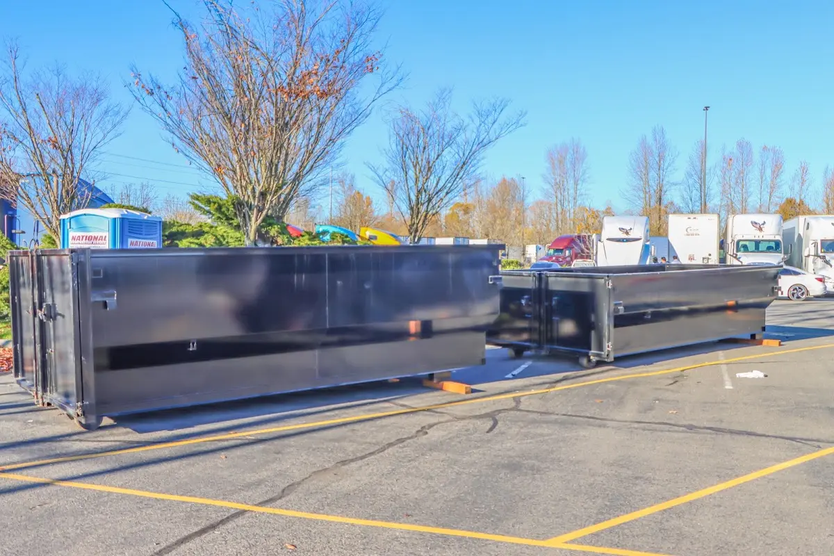 Professional dumpster rental service with roll-off container on residential driveway in Duncanville